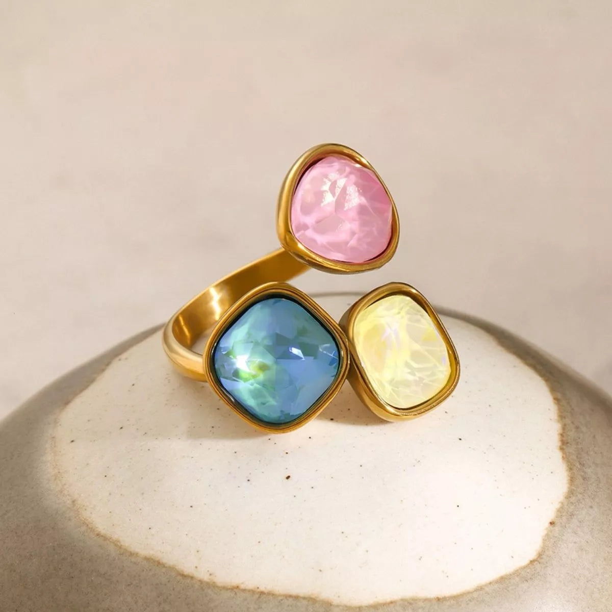 Adjustable 18k gold plated ring with pink, blue, and yellow gemstone rhinestones in a stylish bypass design