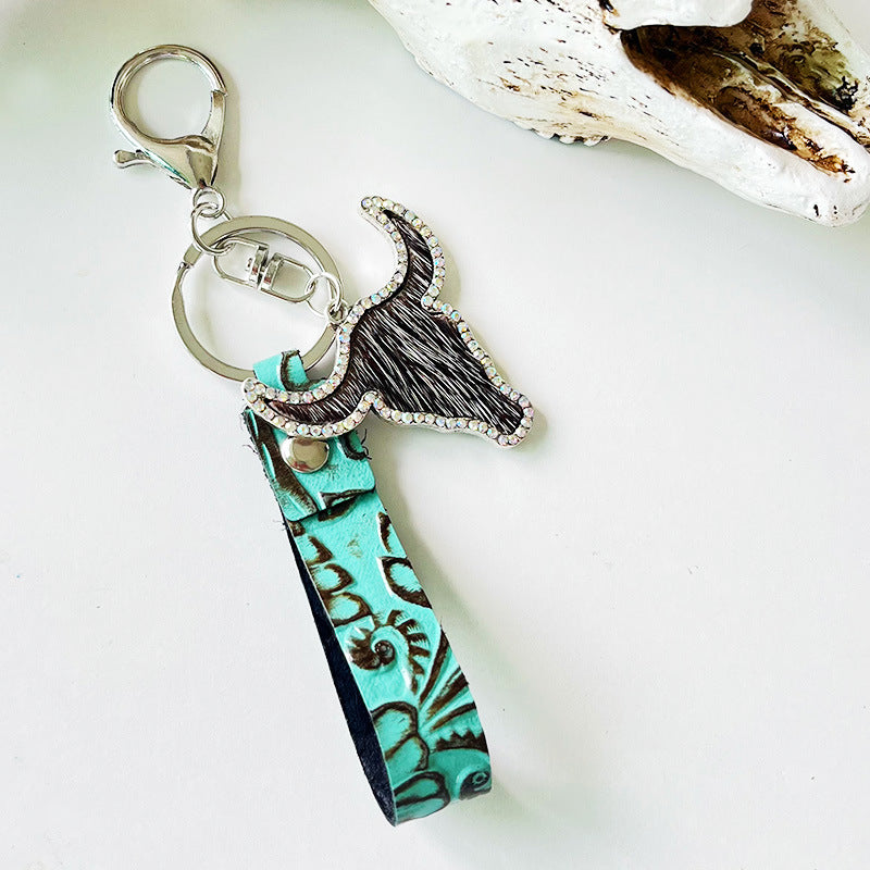 Rhinestone bull keychain with genuine leather turquoise strap and silver alloy hardware, measuring 5.8 inches long.