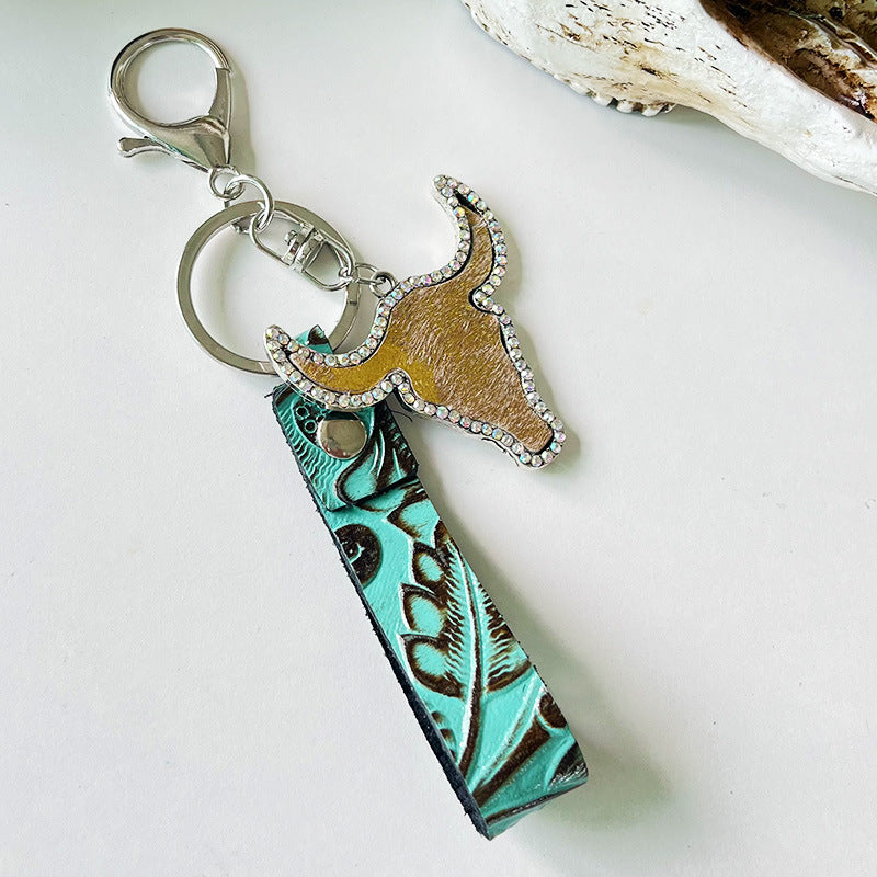 Rhinestone bull head keychain with genuine leather turquoise strap and silver alloy hardware, measuring 5.8 inches long