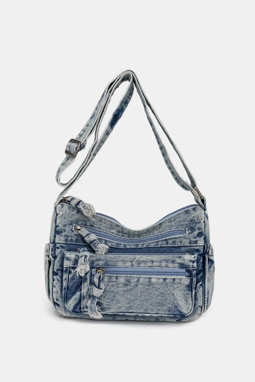 Medium-sized durable denim crossbody bag with multiple zippered pockets and adjustable shoulder strap.