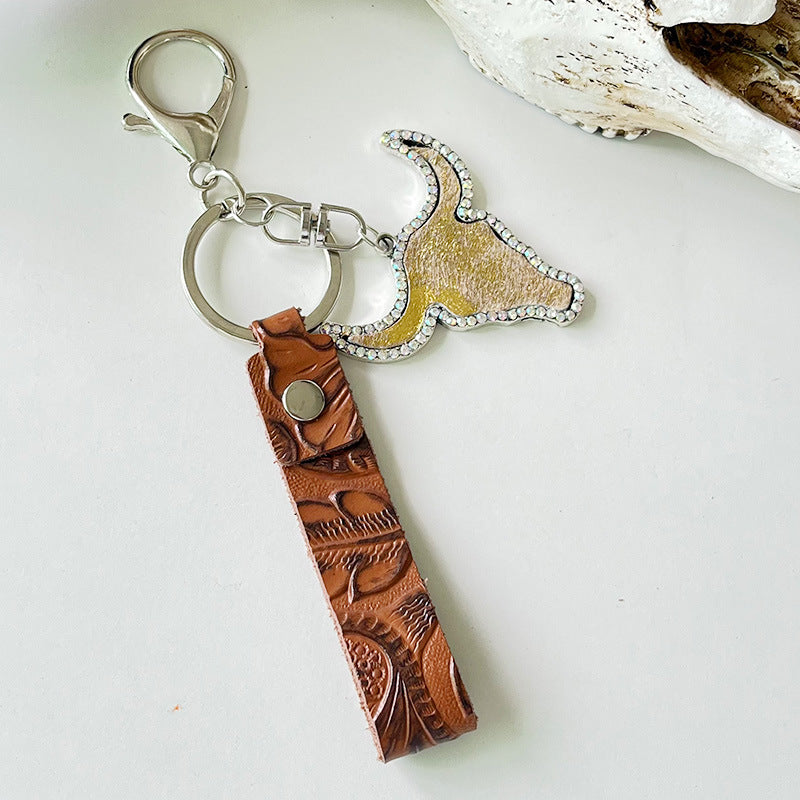 Rhinestone bull head keychain with genuine leather strap and alloy hardware measuring 5.8 inches long