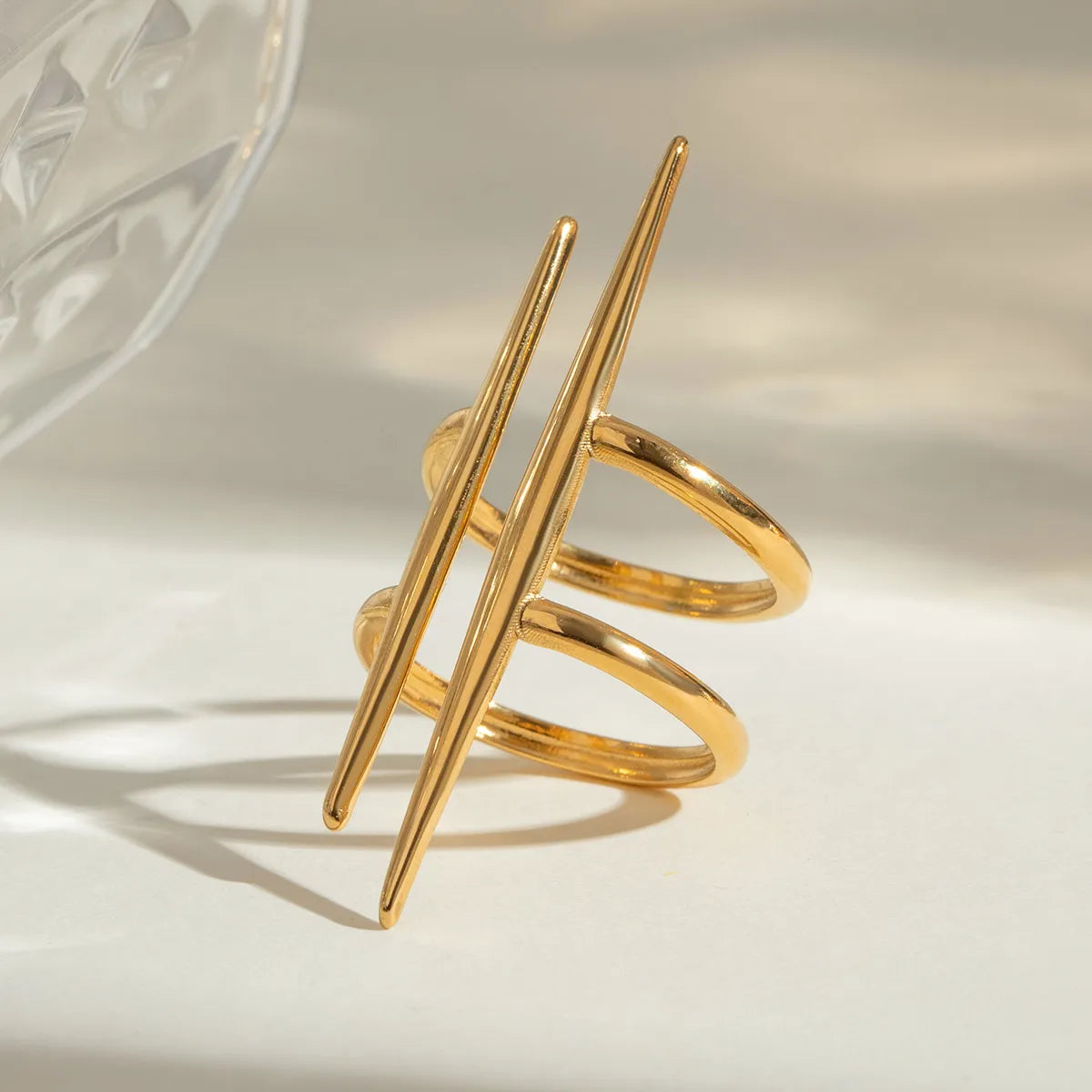 Gold-plated stainless steel ring with an elegant asymmetrical double band design, perfect for modern fashion styles.