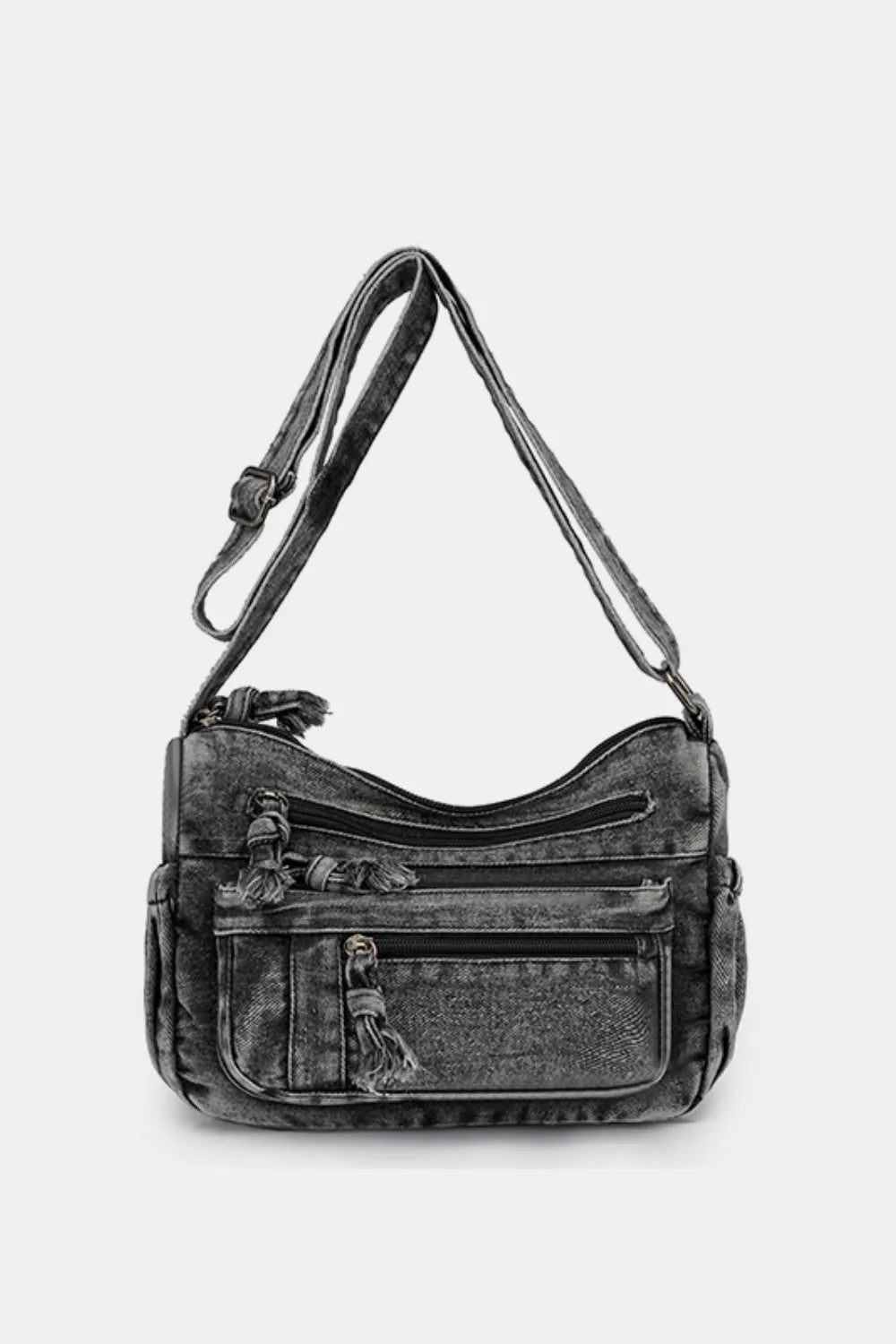 Black denim crossbody bag with multiple zippered pockets and adjustable shoulder strap against a white background