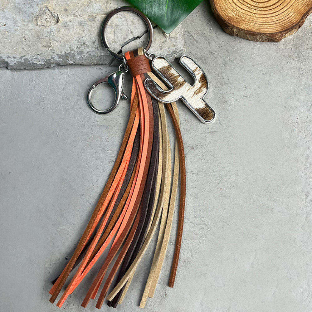 Cactus-shaped alloy keychain with multi-colored cowhide tassel on a metal ring and clip accessory.