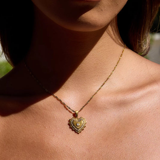 18K gold-plated heart pendant necklace with sparkling zircon accents on a delicate chain worn on a woman's neck