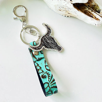 Rhinestone bull keychain with genuine leather turquoise strap and silver alloy hardware, measuring 5.8 inches long.