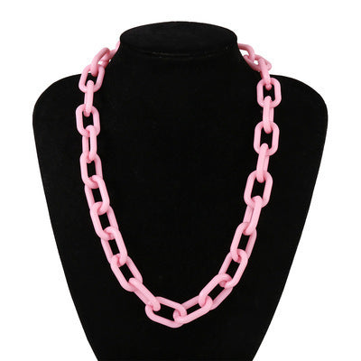 Chunky pink acrylic link chain necklace displayed on a black mannequin, trendy women's punk style accessory.