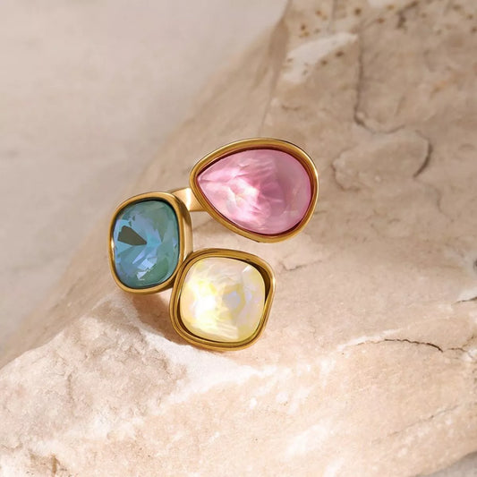 Adjustable 18k gold plated ring with pink, blue, and yellow gemstone rhinestones set in an elegant bypass design